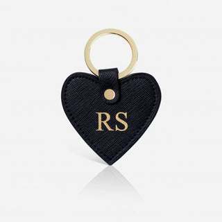 Black heart-shaped keychain with gold initials 'RS' on a white background