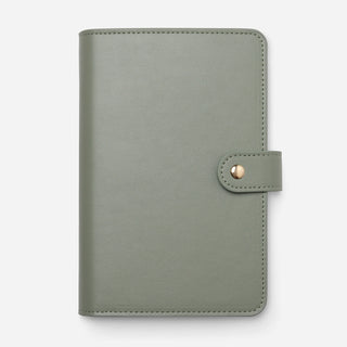 A sage green leather planner cover with a snap-button closure, shown flat against a light gray background.