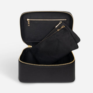 Open black leather vanity case with two removable makeup pouches and internal zip pocket